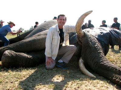 Scott Baker with a bull elephant tranquilized for a health assessment by veterinarians from Kruger National Park, South Africa.