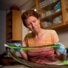 Kathleen Hunt looks down at baleen that she is holding in her hands